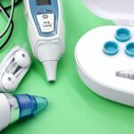 Ear wax removal tools and accessories on a green background